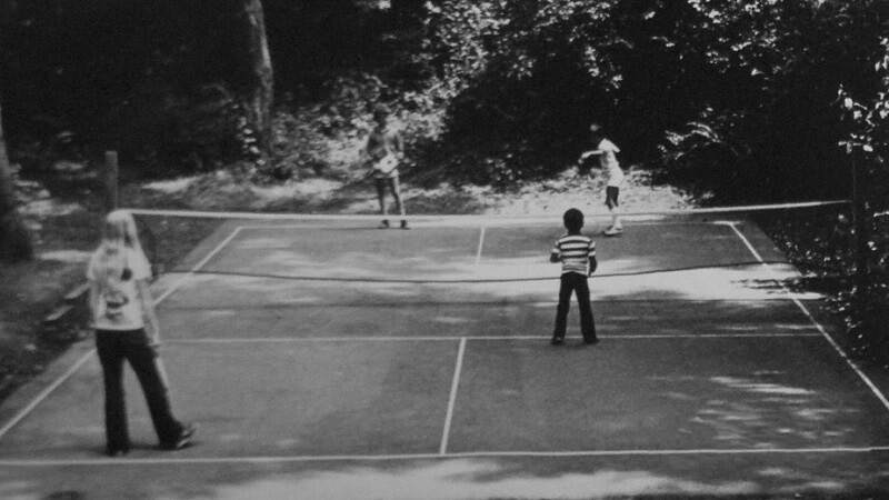 four-people-playing-pickleball-in-backyard