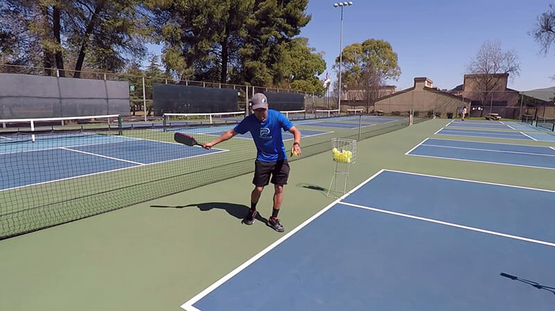 feet behind the base line when serving pickleball