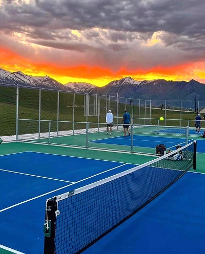 playing pickleball in sunset